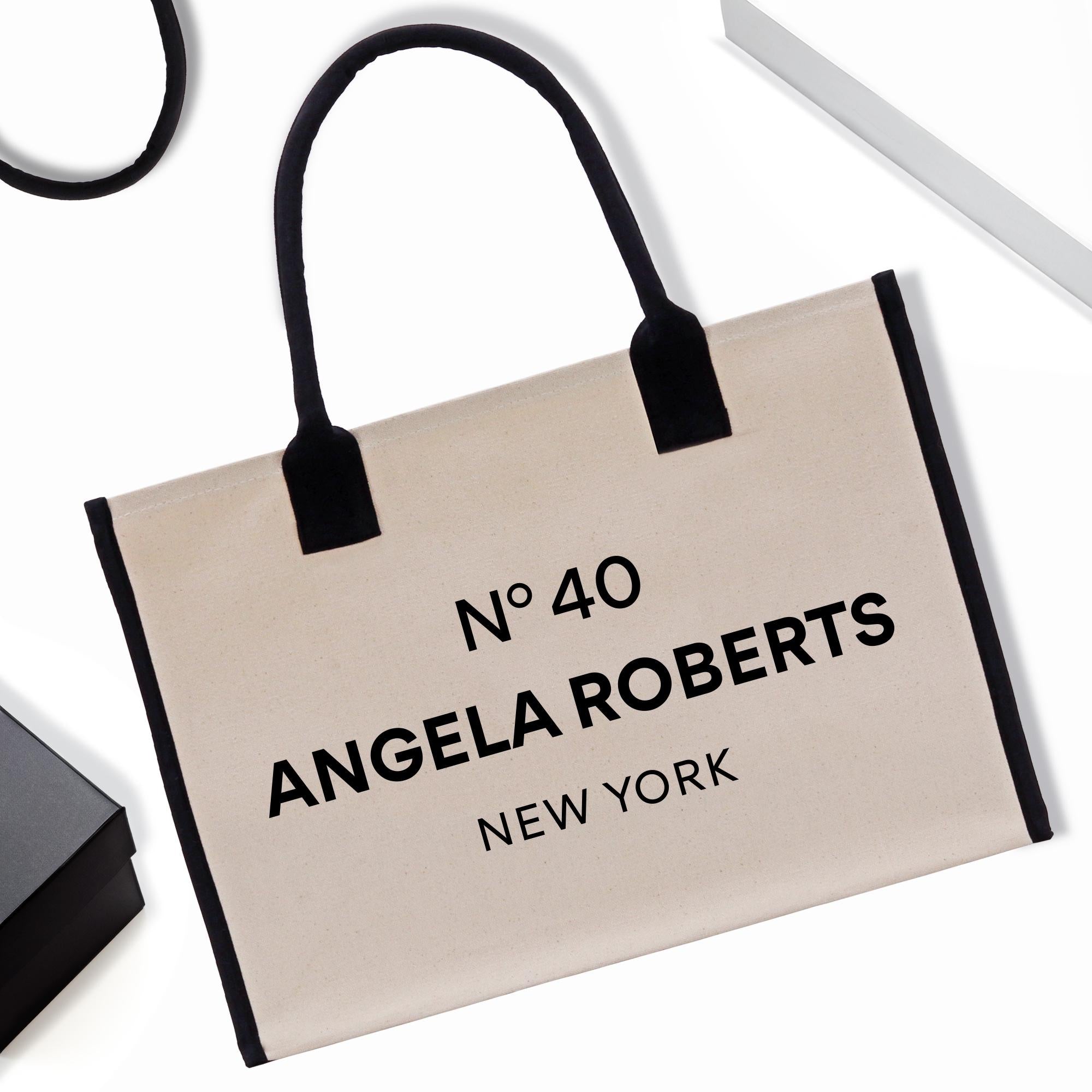 a black and white bag with the name of an angela roberts brand