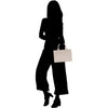 a silhouette of a woman holding a shopping bag