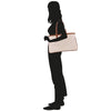 a silhouette of a woman carrying a bag