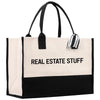 a black and white tote bag with the words real estate stuff on it