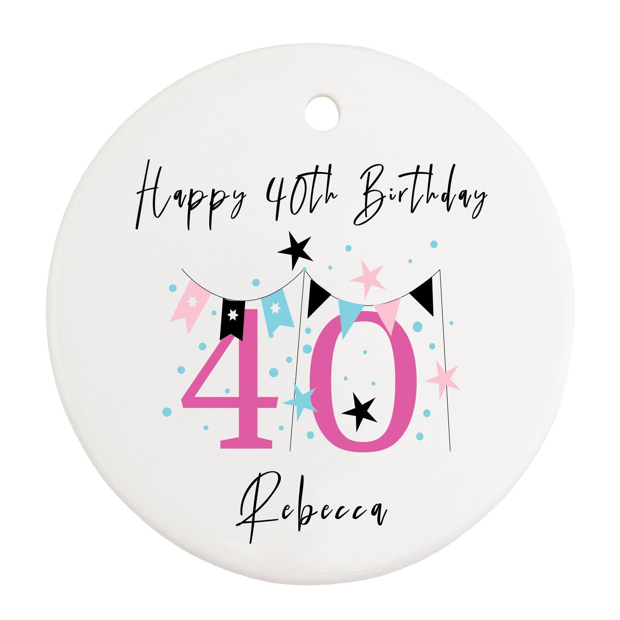 a white birthday ornament with a pink and black number forty