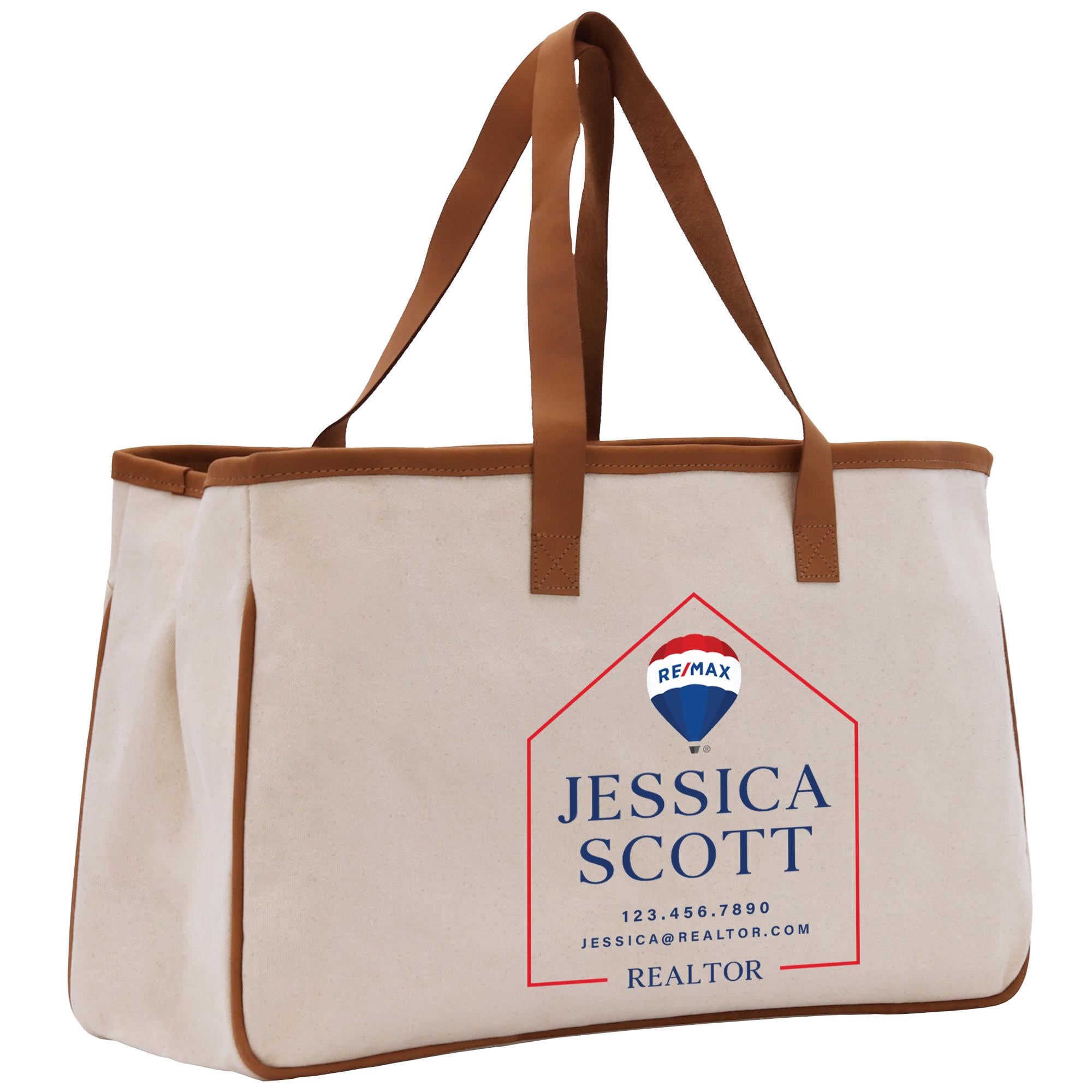 a canvas tote bag with a brown leather handle