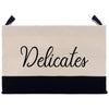 a black and white bag with the word delicates on it