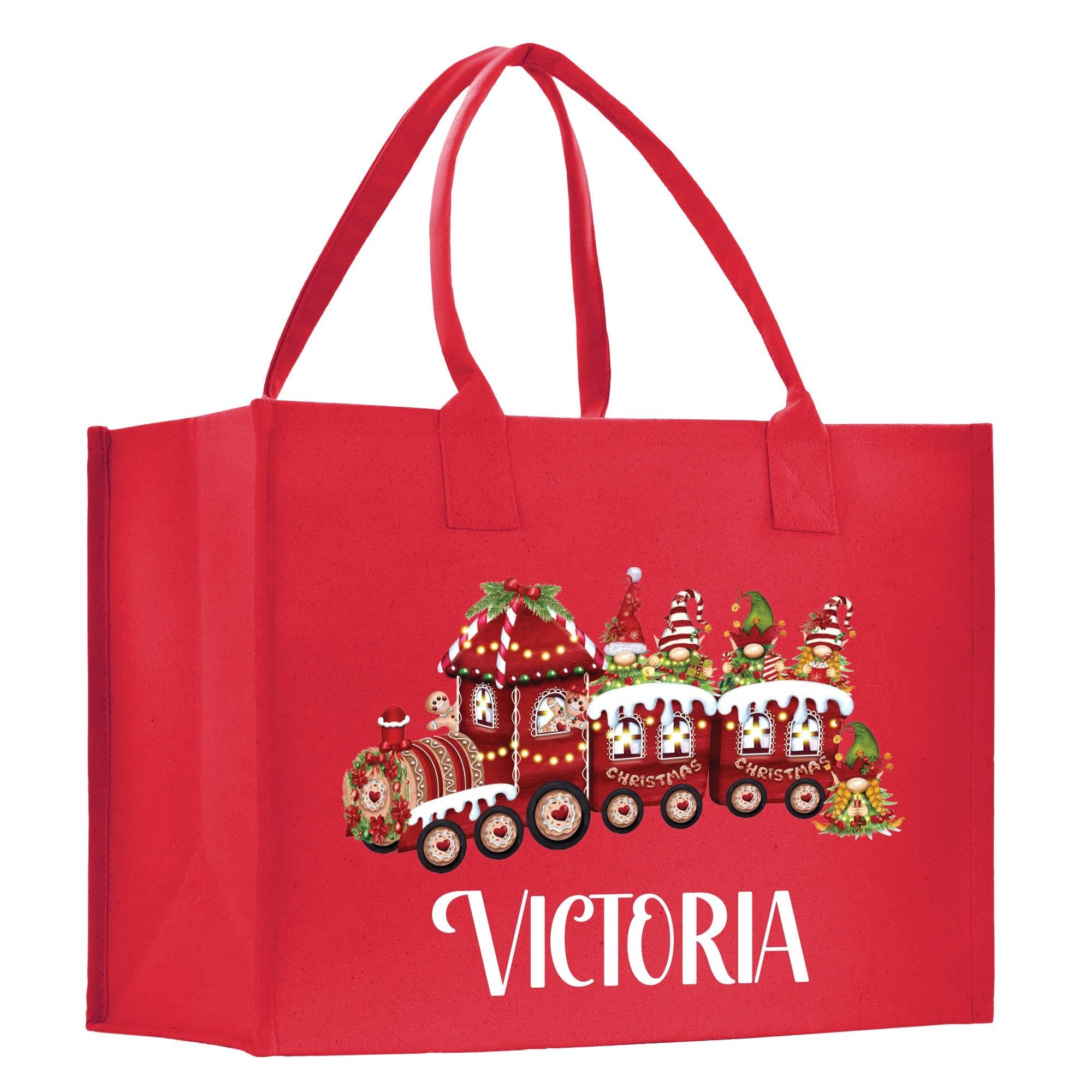 a red shopping bag with a christmas train on it