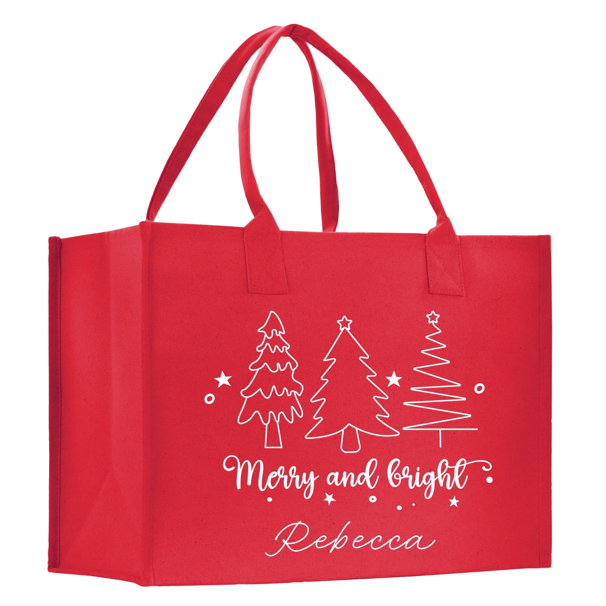 a red shopping bag with a christmas tree on it