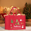 a red shopping bag with a christmas tree on it