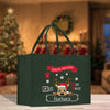 a green shopping bag with a reindeer on it