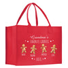 a red shopping bag with three gingerbreads on it