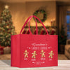 a red shopping bag with three gingerbreads on it