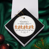 a christmas ornament with a picture of a group of gingers on it