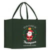 a green shopping bag with a santa clause on it