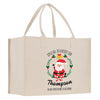 a white shopping bag with a santa clause on it