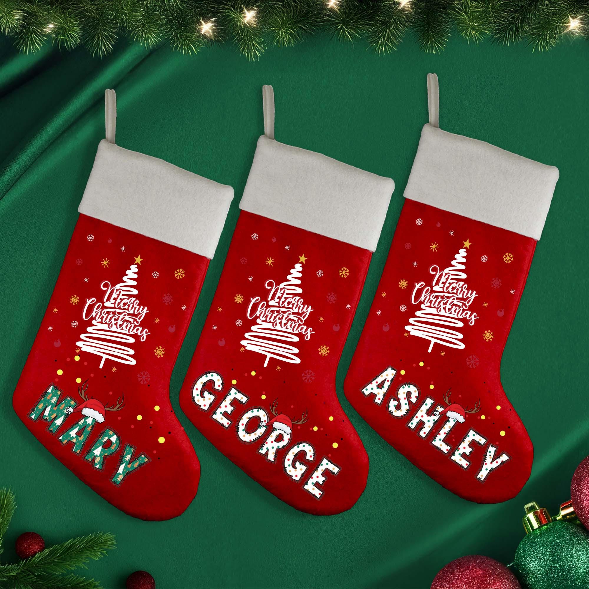 three christmas stockings hanging from a christmas tree