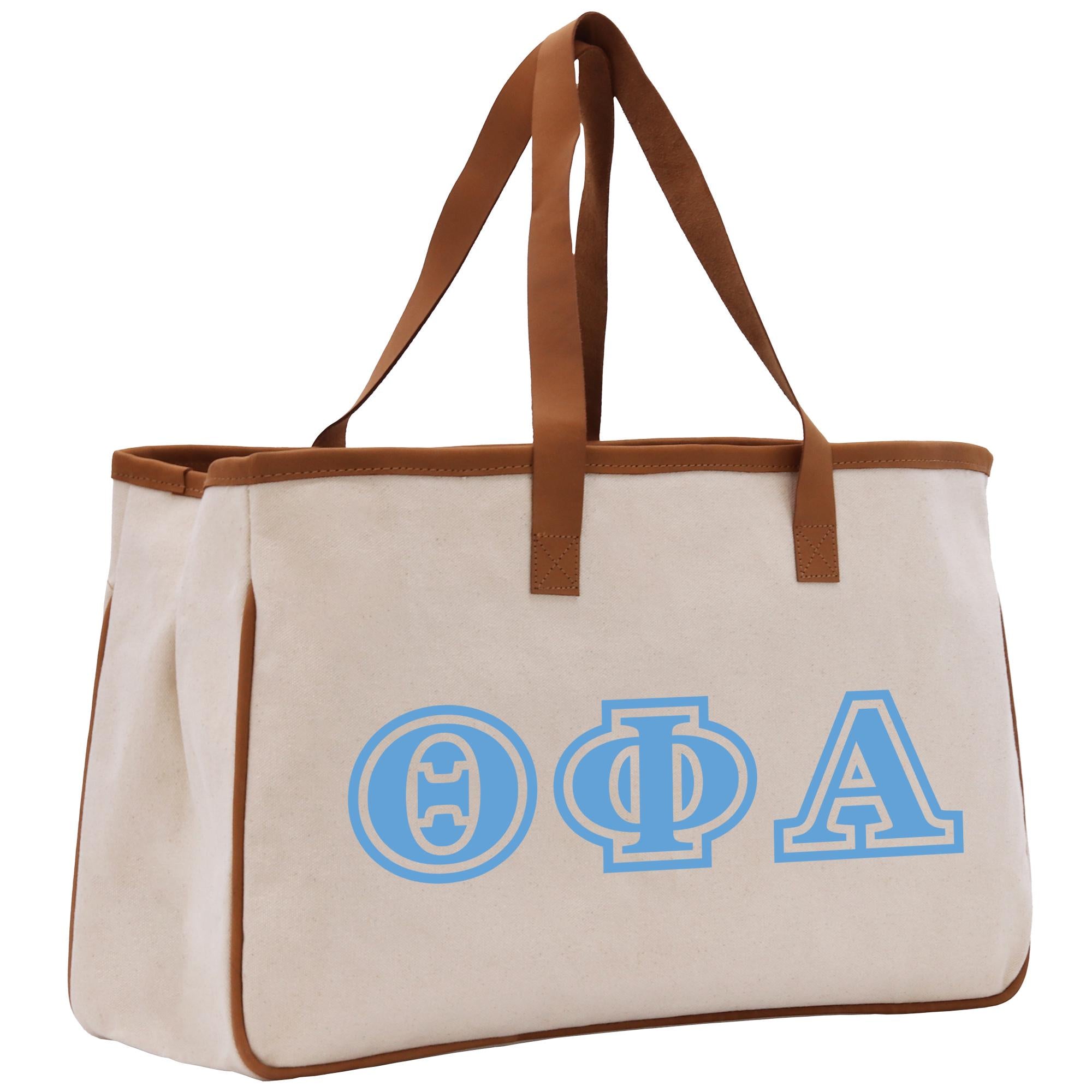 a white bag with blue letters and a brown strap