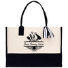 a black and white tote bag with scissors and a bow