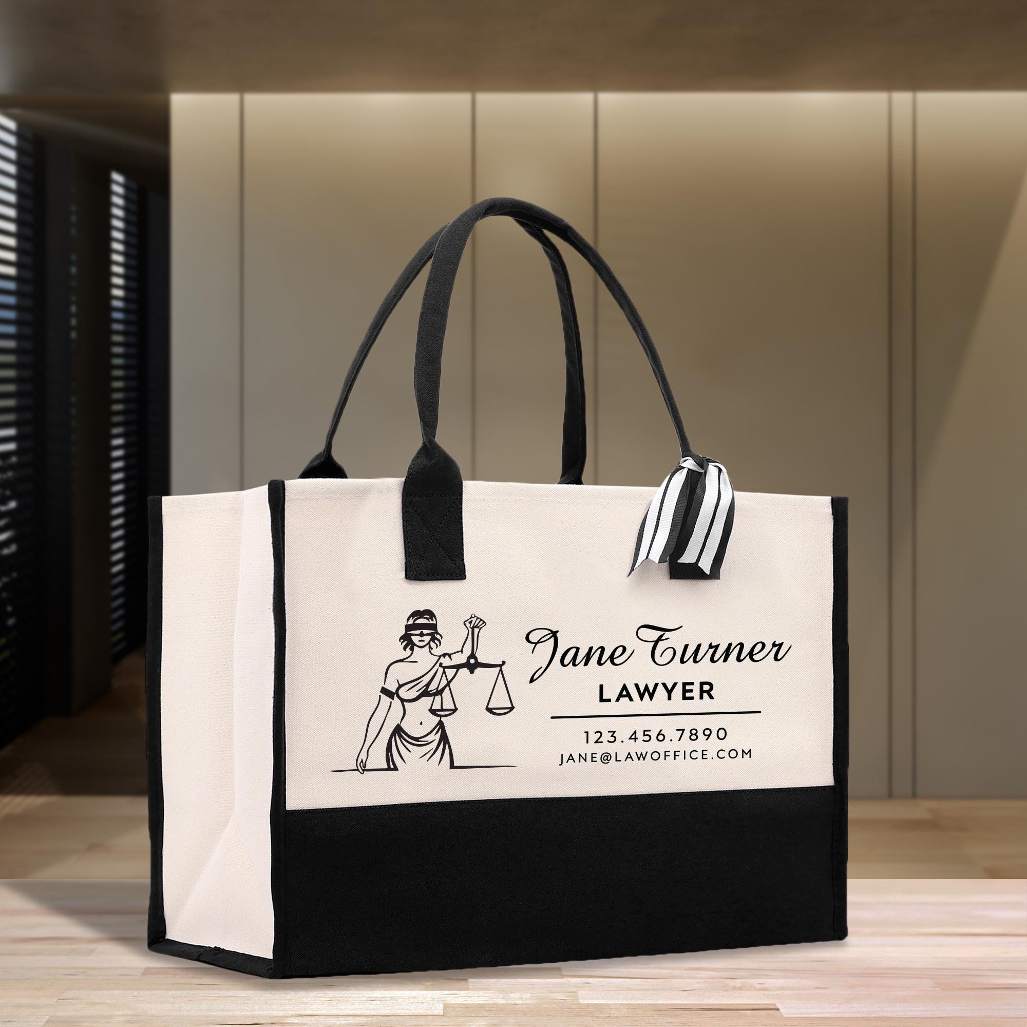 a white and black bag with a lady justice label