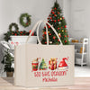 a christmas shopping bag sitting on top of a wooden table