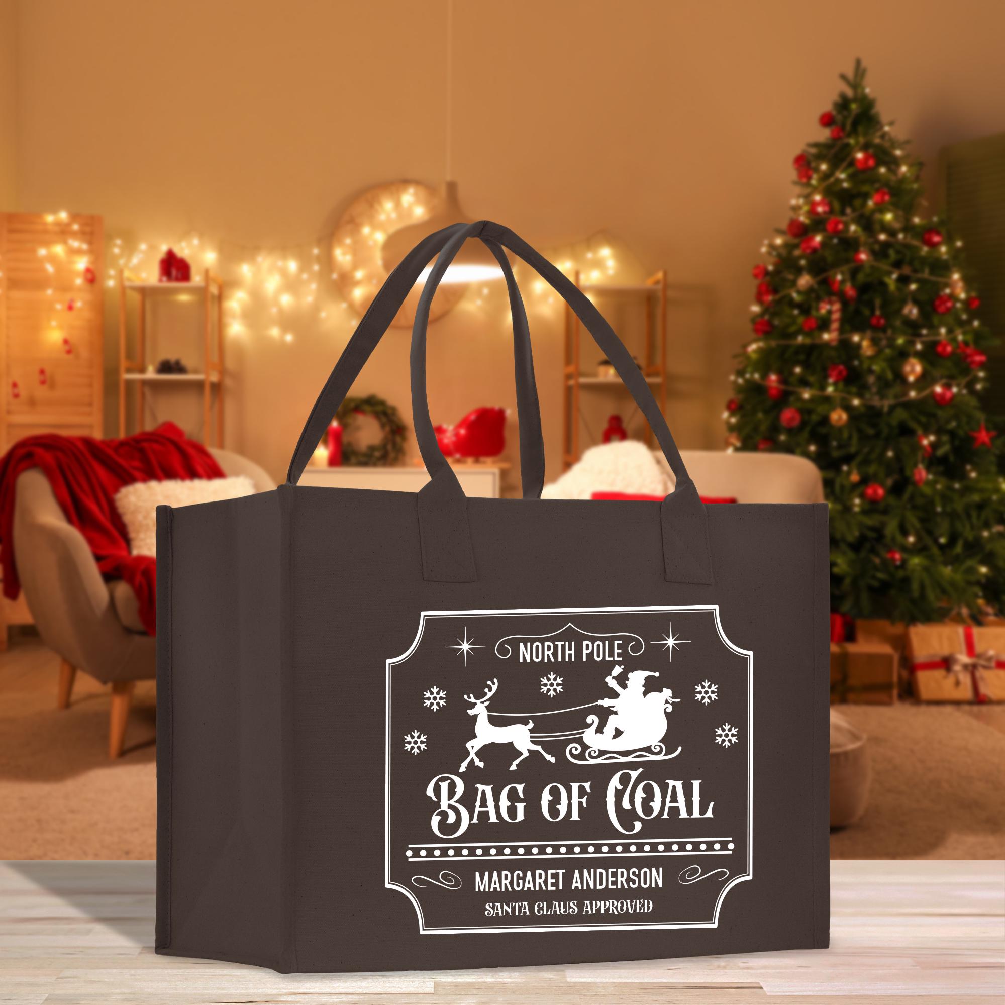 a black shopping bag with a christmas tree in the background