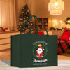 a green shopping bag with a santa clause on it