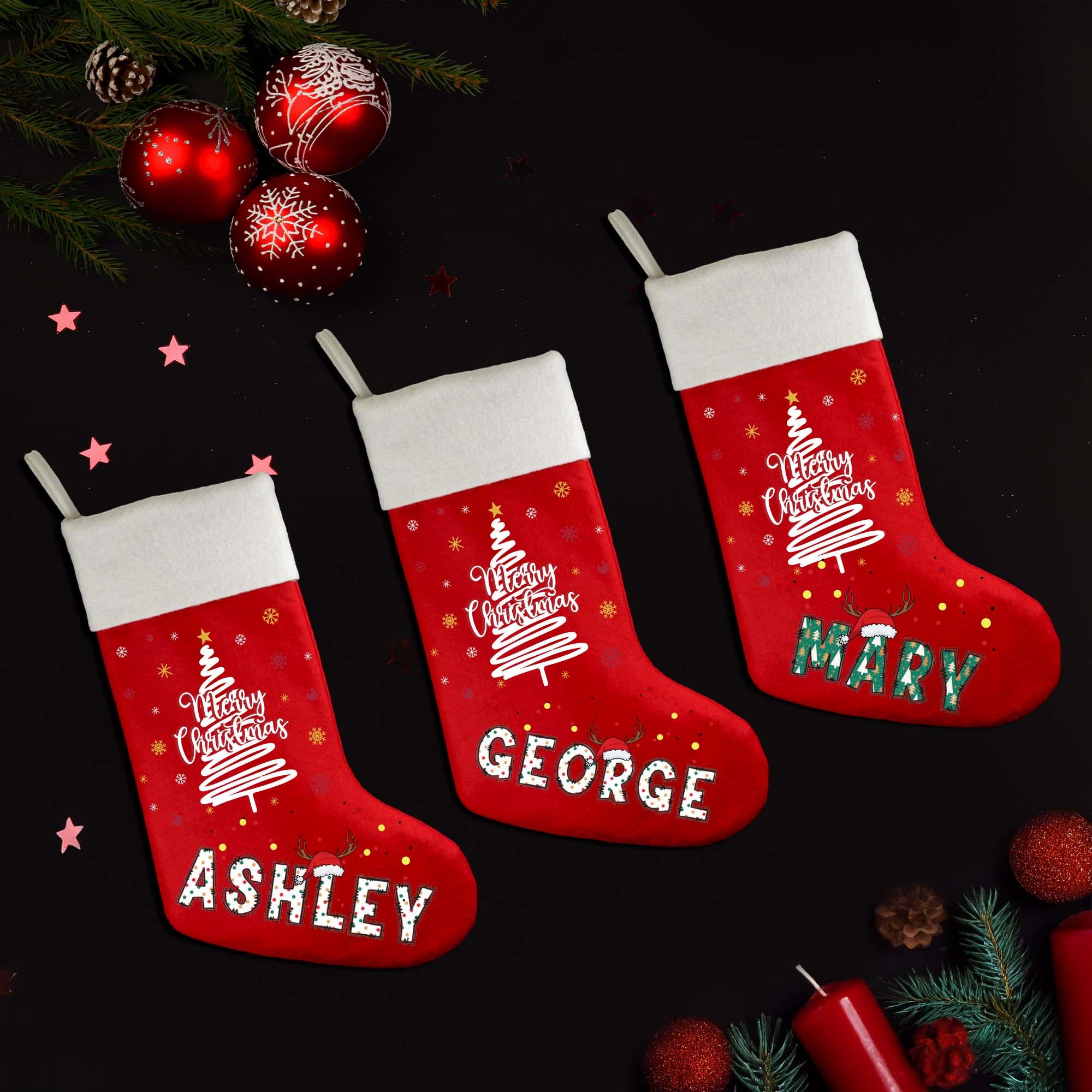 three christmas stockings hanging from a christmas tree