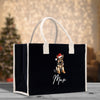a black shopping bag with a german shepard dog wearing a santa hat