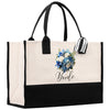 a black and white tote bag with a bouquet of flowers