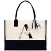 a black and white tote bag with a monogrammed letter