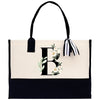 a black and white handbag with a flower monogrammed on it