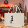 a white shopping bag with a german shepard dog wearing a santa hat