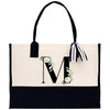 a black and white bag with a monogrammed m on it