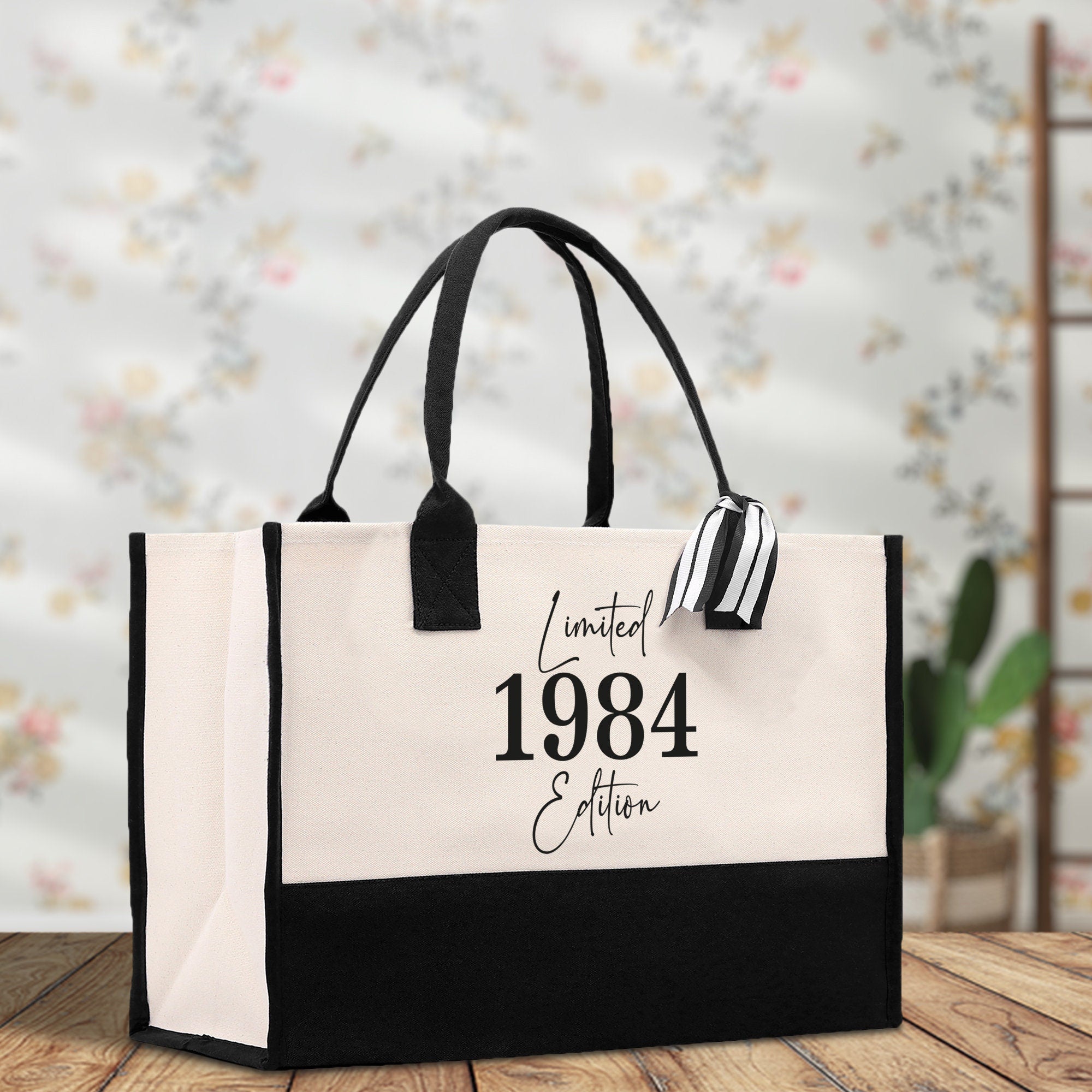 a black and white shopping bag with a date printed on it