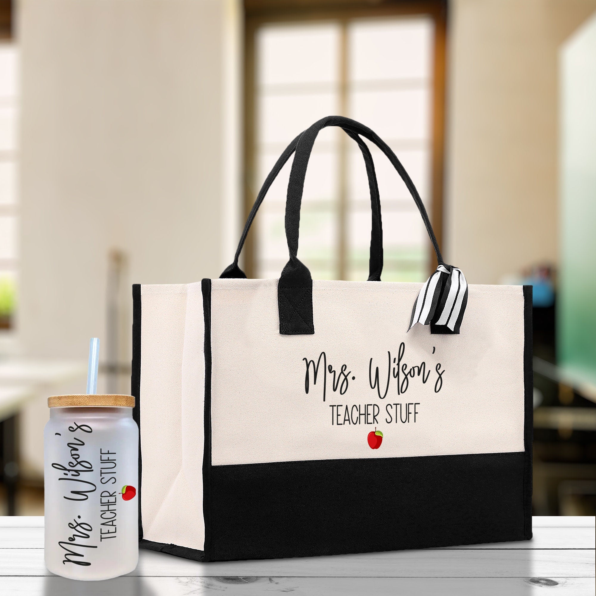 a black and white bag with a bottle of water next to it