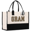 a black and white bag with the word gram on it