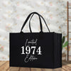 a black shopping bag with the words united 1974 written on it
