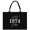a black tote bag with white lettering on it