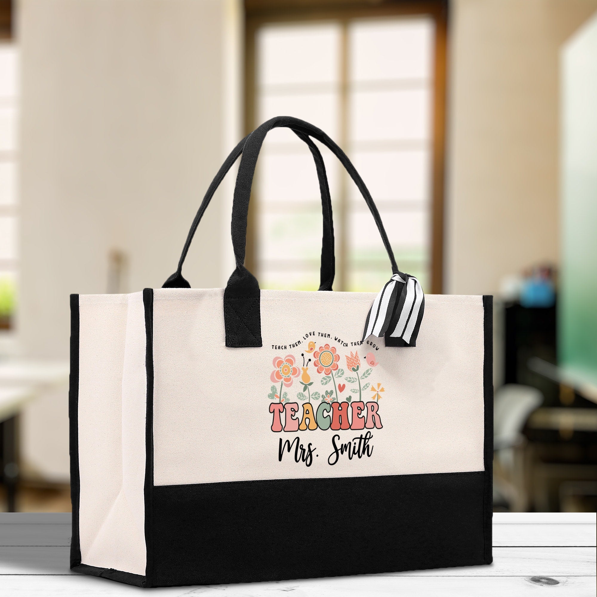 a black and white bag with a teacher on it