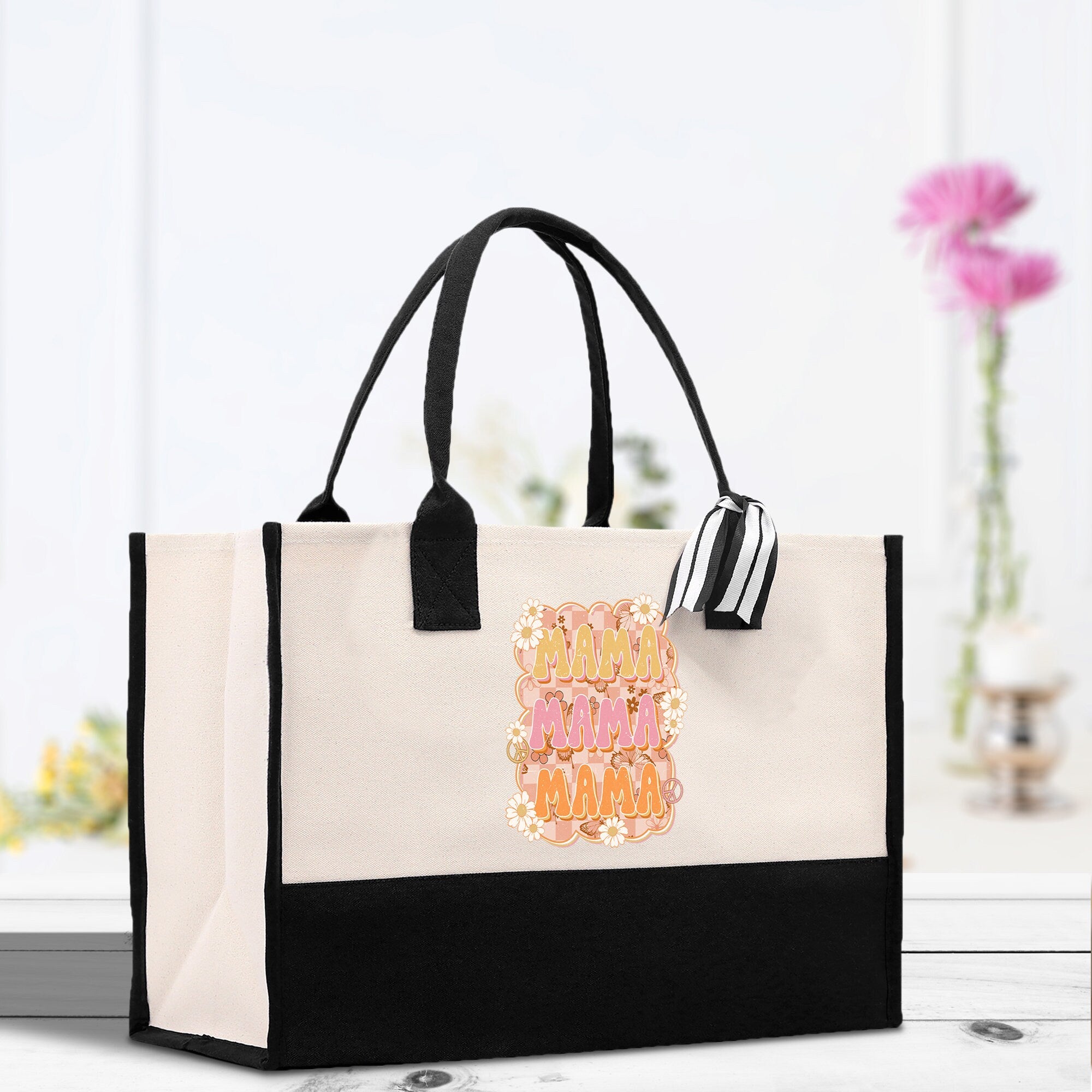 a black and white bag with a pink and orange design