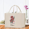 a white shopping bag with red flowers on it