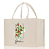 a white shopping bag with a picture of a branch of holly