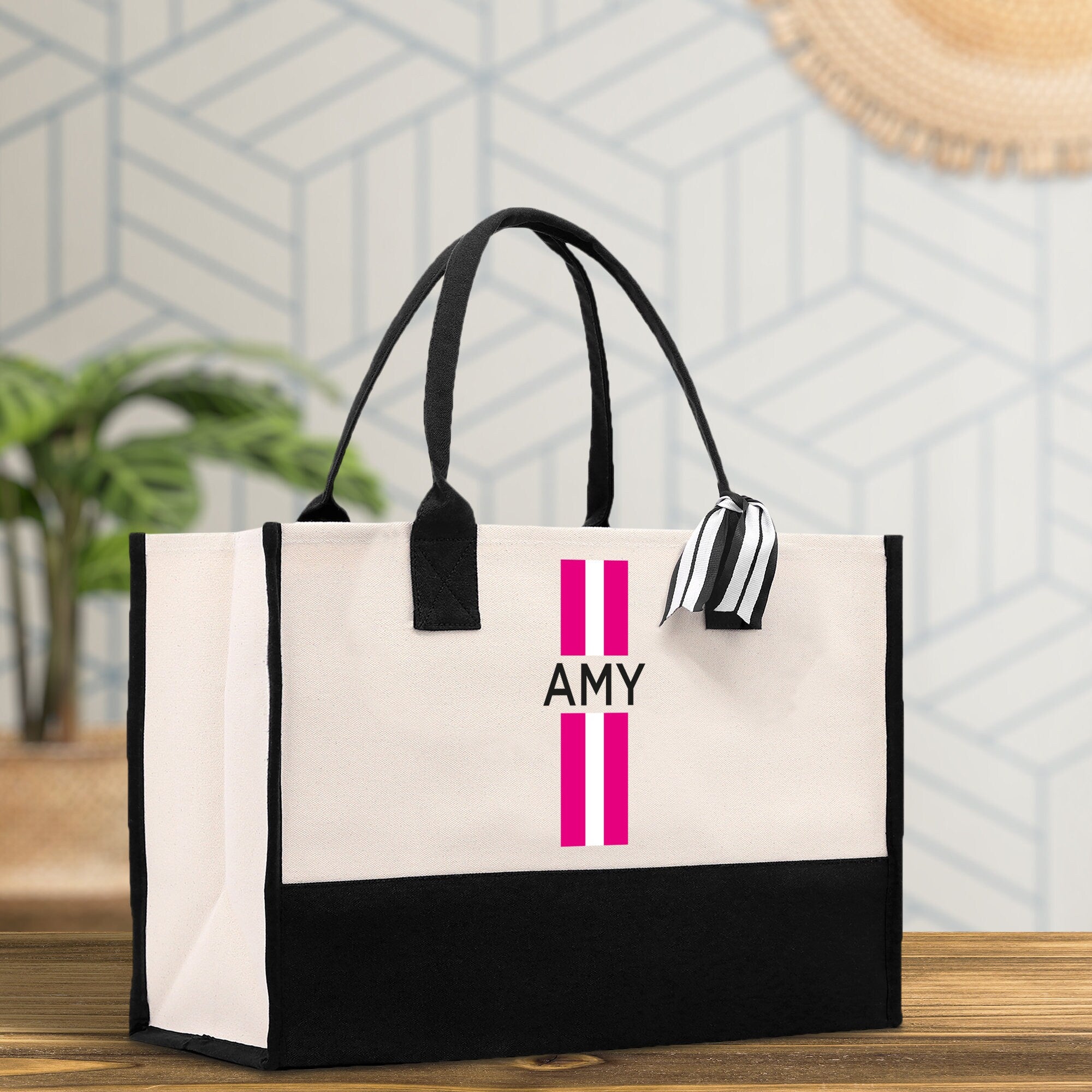 a black and white bag with a pink stripe