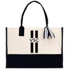 a black and white tote bag with a black and white striped handle