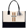 a mom's tote bag with a tassel hanging from it