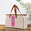 a canvas tote bag with a pink stripe on the side