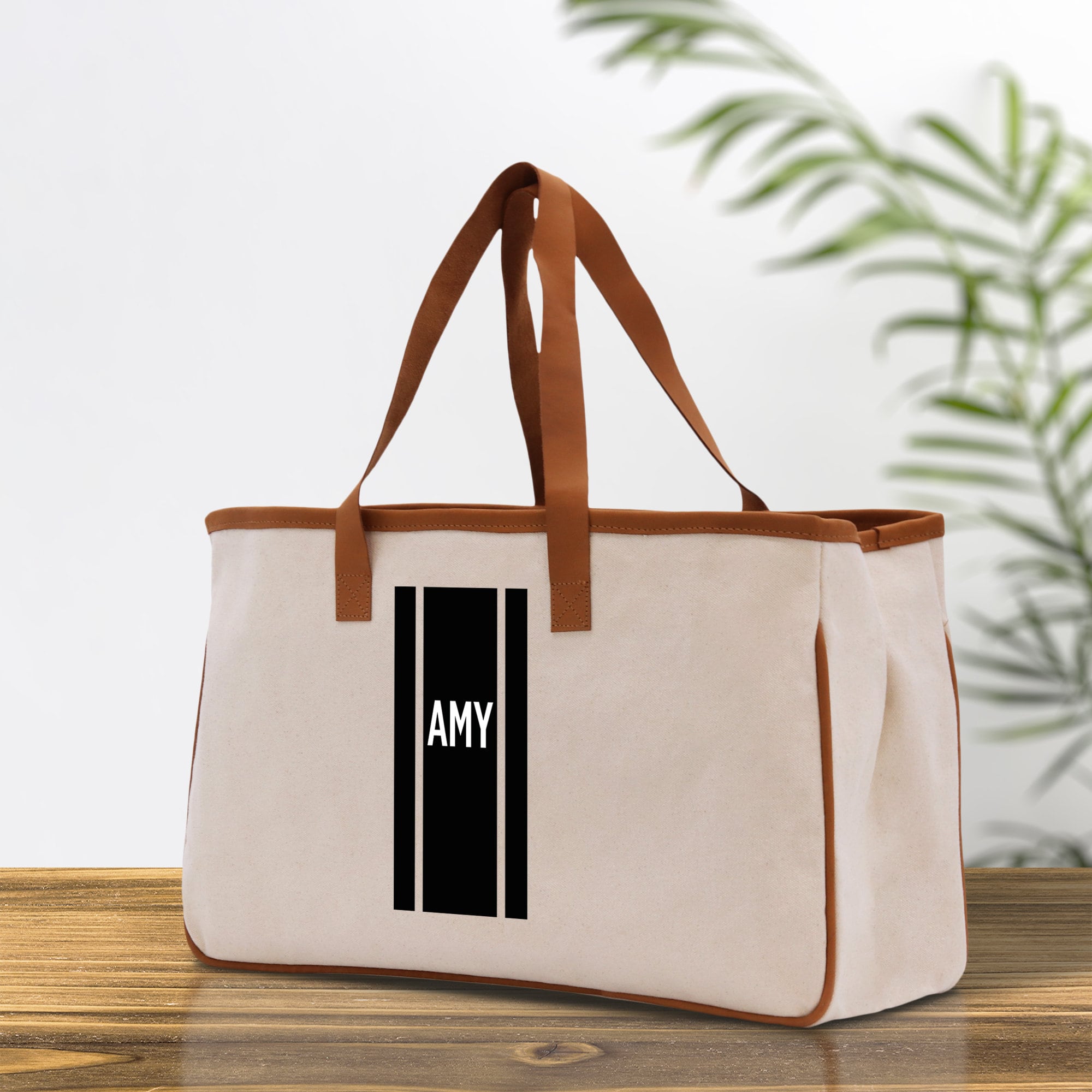 a canvas tote bag with a black and white logo