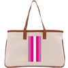 a pink and white striped bag with brown handles