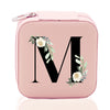 a pink lunch box with a floral monogrammed letter m