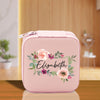a pink lunch box with a floral design