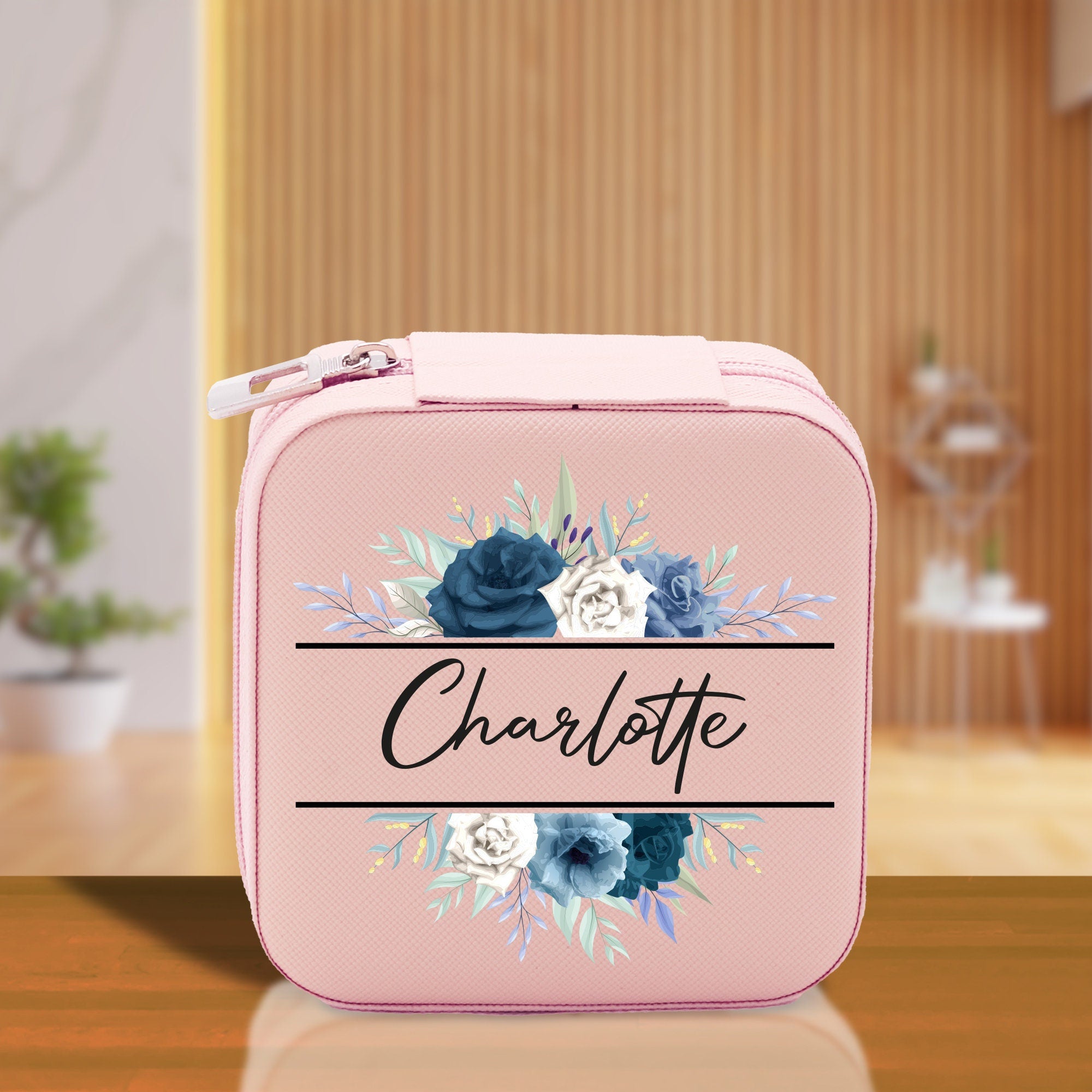 a pink lunch box with flowers on it