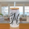 a white mason jar with a black monogrammed m on it