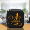 a black and orange lunch box with the letter a on it